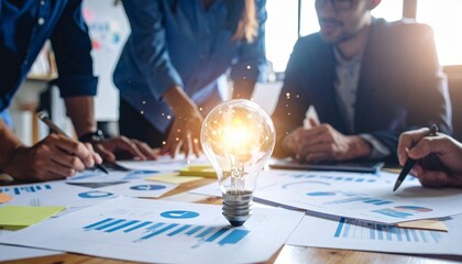 Team brainstorming with glowing idea bulb and charts