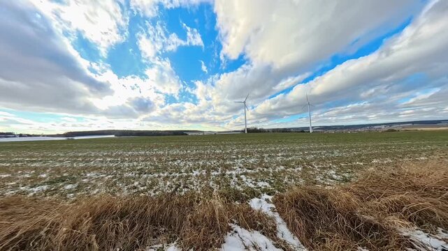 4K Timelapse video with moving clouds and wind power plants near Kugl, Simbach bei Landau, Dingolfing-Landau, Bavaria, Germany