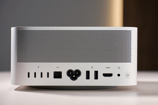 Back panel of Apple Mac Studio Max desktop computer with ports and ventilation grille on white background