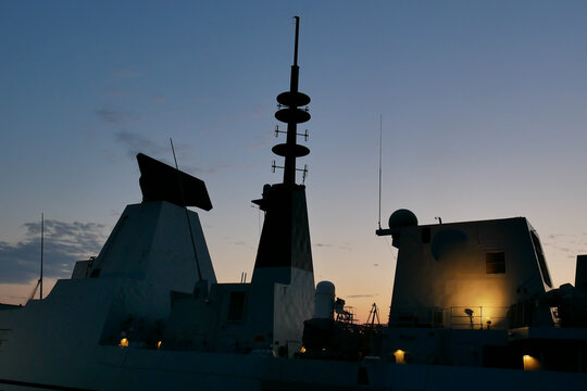 silhouette of a warship at sunset