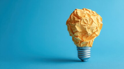 Crumpled paper light bulb representing failed idea