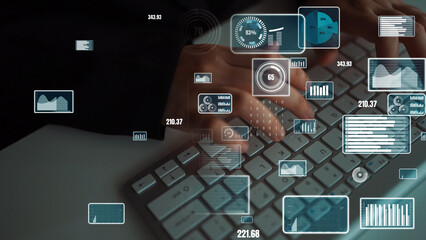 Close-up of hands typing on a computer keyboard with digital graphs and statistics displayed above,...