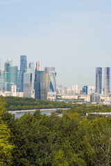 Fototapeta premium Moscow financial district view on a sunny summer day, Russia. Travel destinations and sightseeing viewpoint on the Vorobyevy Hills near the Moscow State University historical building