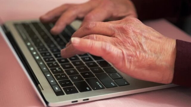 Senior Review Activity - Elderly Person Scrutinizing Online Financial Statements - Senior Individual Attentively Overseeing Electronic Transactions While Seated At Kitchen Table In Focused Moment