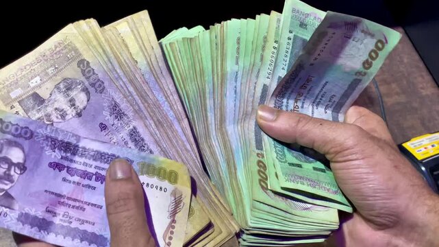 Hand Holding Bangladeshi Taka 500 and 1000 Banknotes &ndash; Cash Money Finance Concept