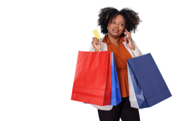 Black woman talking on mobile phone while holding a credit card and shopping bags, enjoying a consumer culture