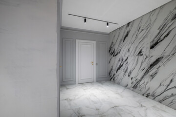 long empty corridor in interior of entrance hall without furniture of modern apartments, office or...