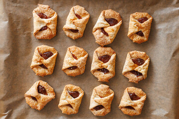 Close-up of homemade puff pastry cookies filled with fruit jam