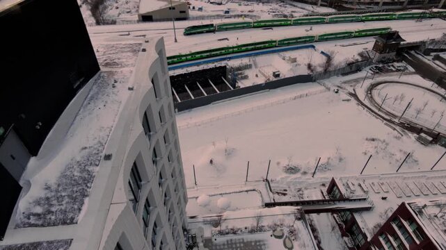 Stunning 4K drone footage of Toronto's iconic skyline at winter sunrise, flying over the Gardiner Expressway bridge amid a pristine snowscape.