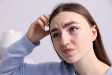 Fototapeta premium Amnesia. Woman trying to remember something at home