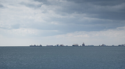 Fototapeta premium Industrial ships anchored and waiting in the open sea.