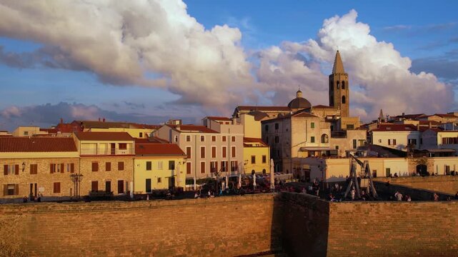 Explore Alghero, Sardinia from above, capturing its stunning historic buildings, coastal features, and vibrant streets. Experience the beauty of this Mediterranean gem.
