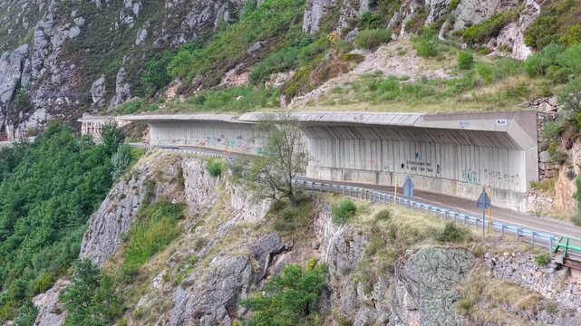 Mountain road under a rockfall protection wall in Spain.