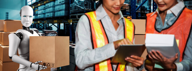 Innovative industry robot working in warehouse together with human worker . Concept of artificial intelligence for industrial revolution and automation manufacturing process .