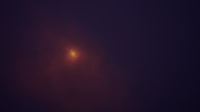 Industrial chimney flaring off excess gas in fog.