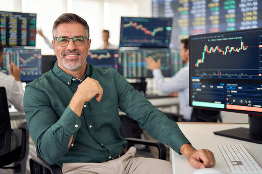 Smiling mature business man crypto broker, financial investor, trader or expert adviser at work, portrait. Digital trade finance exchange market, asset management, stock funds investment analysis.
