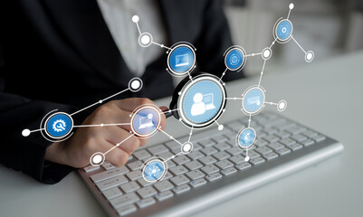A business professional using a keyboard to analyze digital connections and profiles. The image portrays technology and innovation in a modern workspace setting. Crux