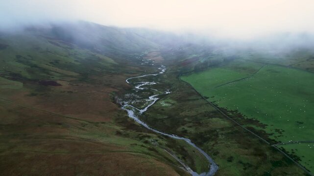 Following up hil Aerial shot foggy day over Cawdale Beck Penrith in Brampton Cumbria UK 54.554784, -2.788044