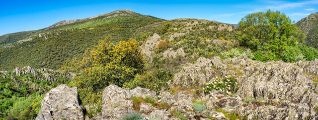 Mountain landscape with high green peaks and rocks of various shapes in an idyllic landscape of central Spain.