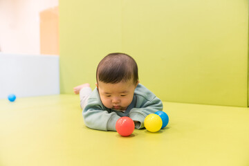 マンションのキッズルームで遊ぶ日本人の男の赤ちゃん