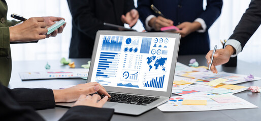 Analyst team use sticky note for creative and analytic brainstorm for business idea with BI data dashboard on laptop screen. Analysis financial data visualization tech for marketing strategy. Prodigy