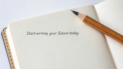 Pencil resting on open notebook with motivational message