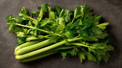 Fresh celery stalk bundle overhead angle showing textured ribbing and leafy tops perfect for organic food packaging design and wellness website photography