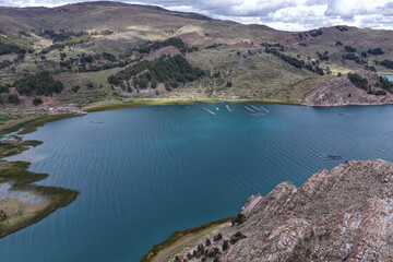 Fototapeta premium Bay with scrubland and natural pastures on the shores of a turquoise lake