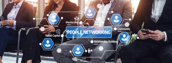 A group of professionals participates in a networking session, engaging with smartphones while exploring digital connections and community building in a modern business environment. Tessel