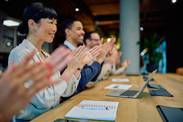 Diverse business professionals applauding, showing appreciation and recognition for achievement in a modern office boardroom