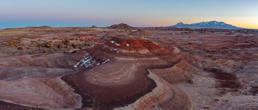 This scenic panorama features the colorful Bentonite Hills of the southern San Rafael Swell near Hanksville, Utah.  In the distance, the Henry Mountains rise above this beautiful desert landscape.