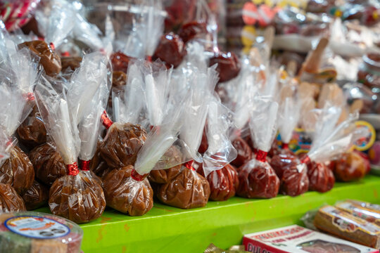 Tamarind tarugos wrapped in cellophane at a traditional candy stall. Typical Mexican sweet made of fruit pulp and sugar. Petatlan, Guerrero, Mexico
