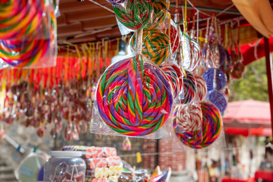 Giant colorful artisanal lollipop at a traditional candy stall in Petatlan. Typical Mexican sweets. Petatlan, Guerrero, Mexico