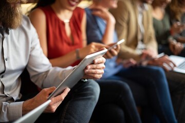 Group of people using tablets and smartphones, focusing on technology and communication. Casual setting with diverse individuals engaged in digital devices. People using digital devices, social media.
