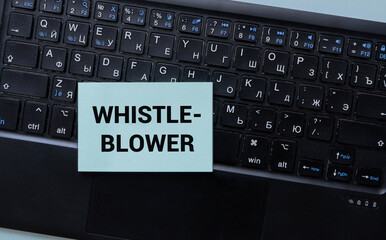 Yellow and green blocks with the words Whistle Blower orange background