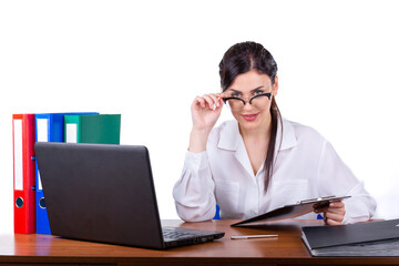 Fototapeta premium Smiling professional businesswoman holding clipboard at office desk with laptop isolated on white background