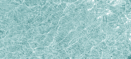 Crystal clear water surface, ripple water in the sea with sun reflection