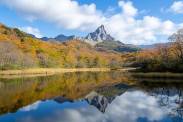 Majestic Mountain Peak Reflected in Autumn Lake Amidst Vibrant Fall Foliage.