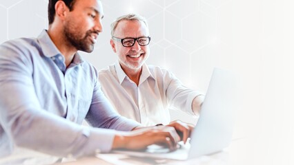 Cheerful web developers working on a laptop