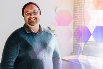 Cheerful man standing by his computer