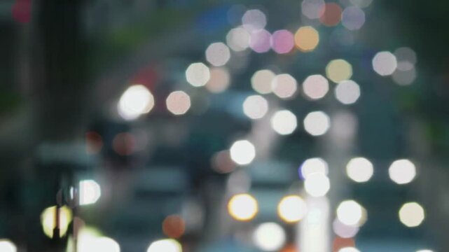 Blurred view of heavy traffic congestion at Sudriman street with cars crowding during rush hour and heavy rain.