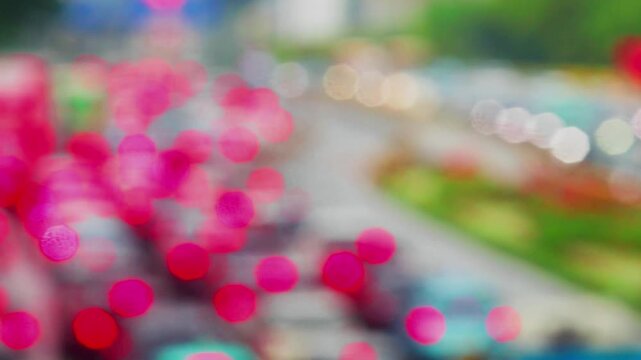 Blurred view of heavy traffic congestion at Sudriman street with cars crowding during rush hour and heavy rain.