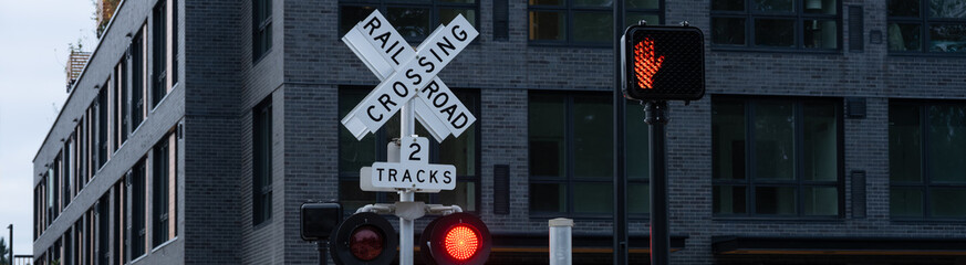 Obraz premium Sound transit light rail commuter train crossing, railroad crossing sign, white X, multiple tracks, yield to train red light flashing, transportation background 