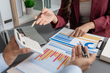 Business colleagues reviewing budget charts together in a modern office, focusing on financial insights, performance metrics, and strategic planning to support upcoming business decisions.
