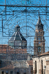 Decorative iron ornament and cathedral view at background, penaranda de bracamonte, spain