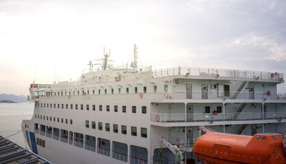 Naklejka premium Large white passenger ship docked at the pier