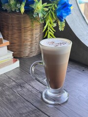 Hot Cappuccino in Modern Glass Cup with Thick Milk Foam and Layered Coffee