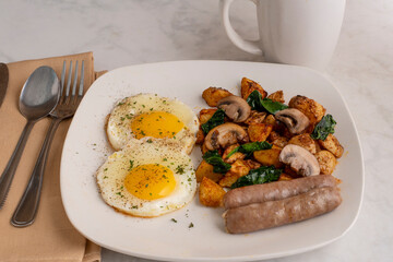 fried eggs  with home fries and breakfast sausages