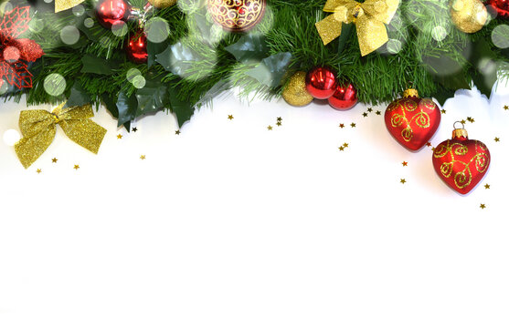 Festive Christmas background featuring an evergreen garland decorated with red and gold ornaments, glitter bows, and holiday accents along the top edge. The clean white copy space below makes it ideal