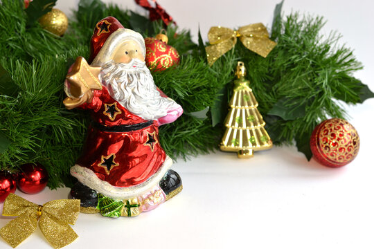 Festive Christmas background featuring an evergreen garland decorated with red and gold ornaments, glitter bows, and holiday accents along the top edge. The clean white copy space below makes it ideal